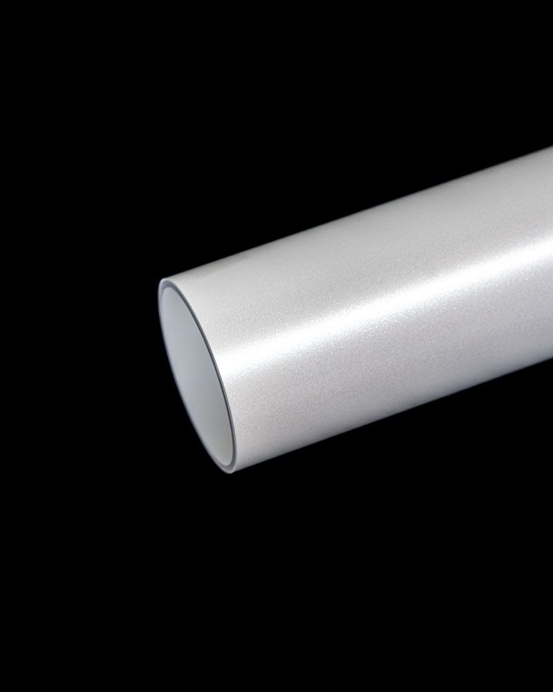 A close up of a white pipe on a black background.