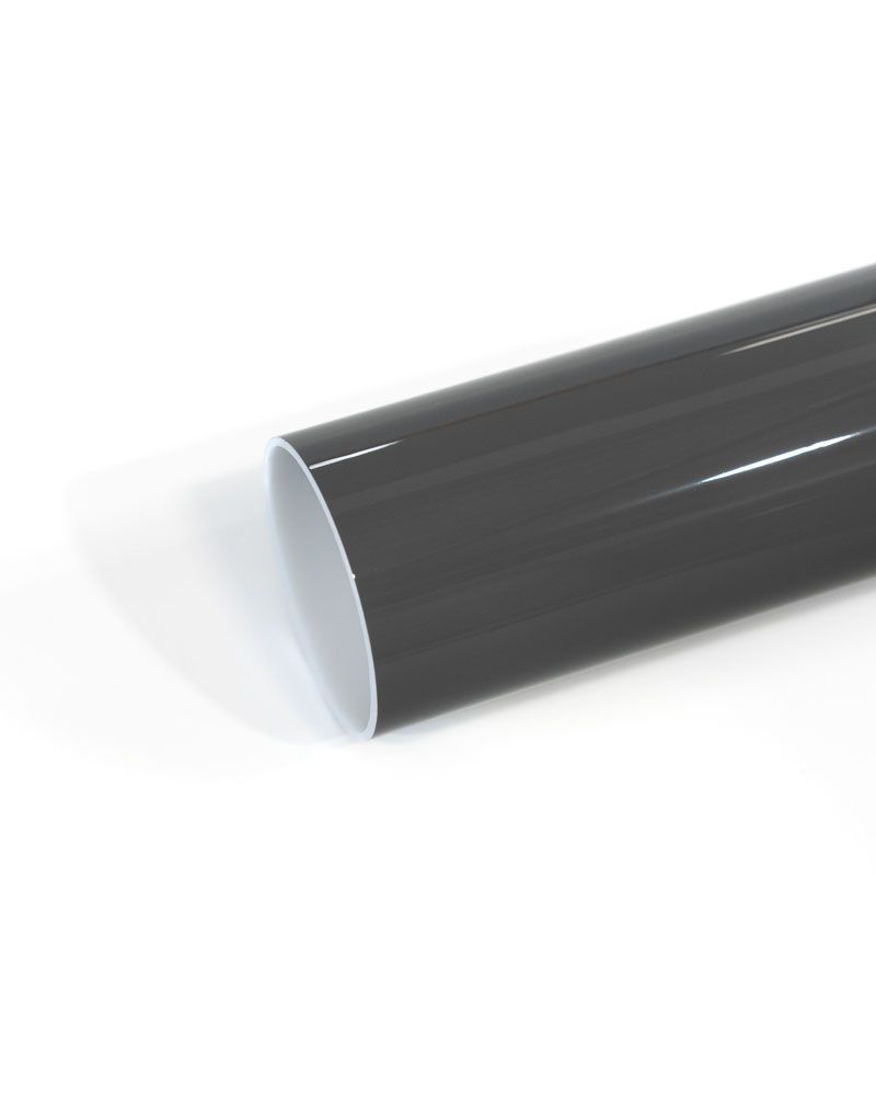A close up of a gray pipe on a white surface.