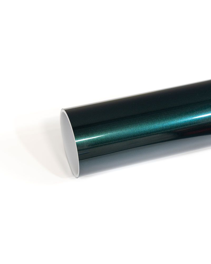A close up of a roll of green vinyl wrap on a white surface.