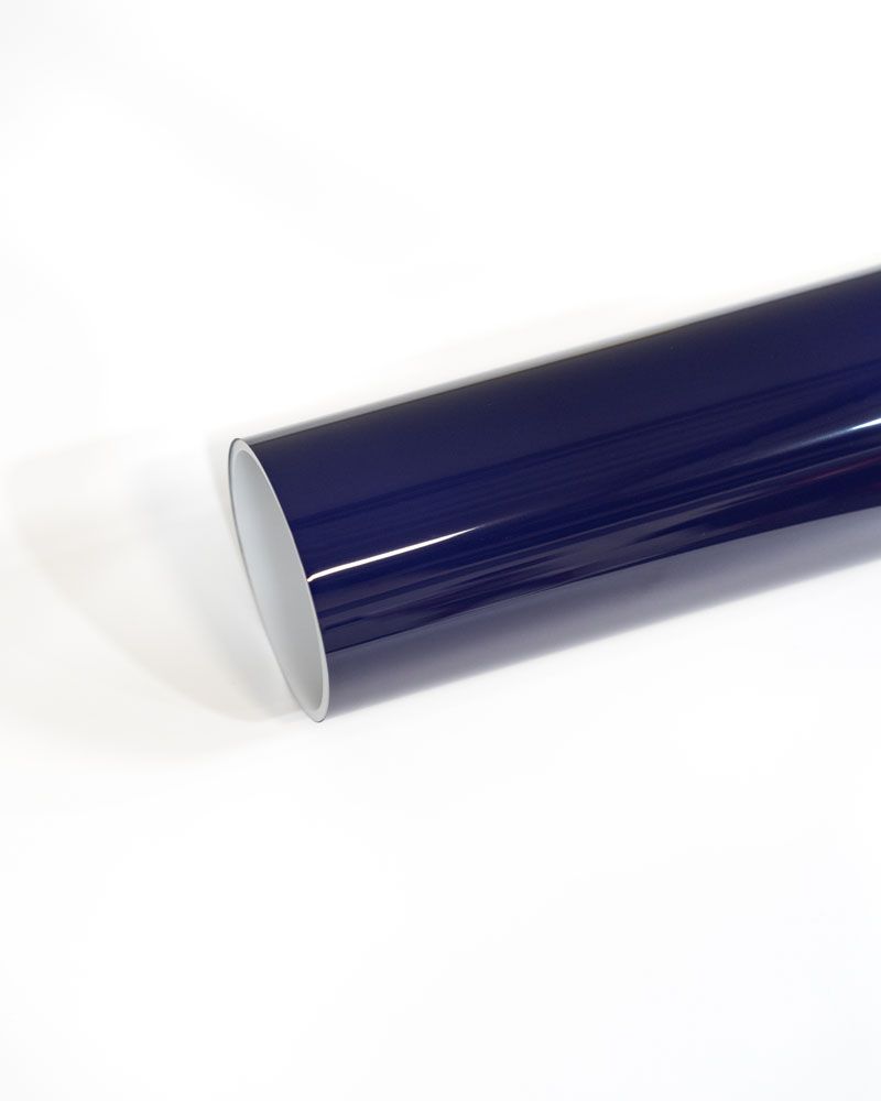 A blue roll of vinyl wrap is sitting on a white surface.