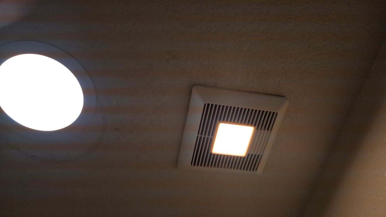 Open electrical panel in stucco wall with exposed wiring above and utility meter below.