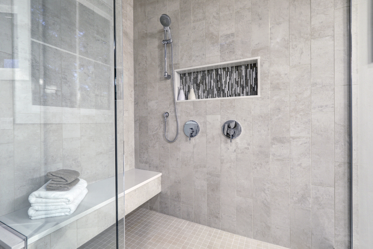 tub-to-shower conversion with white tiles and black matte fixtures
