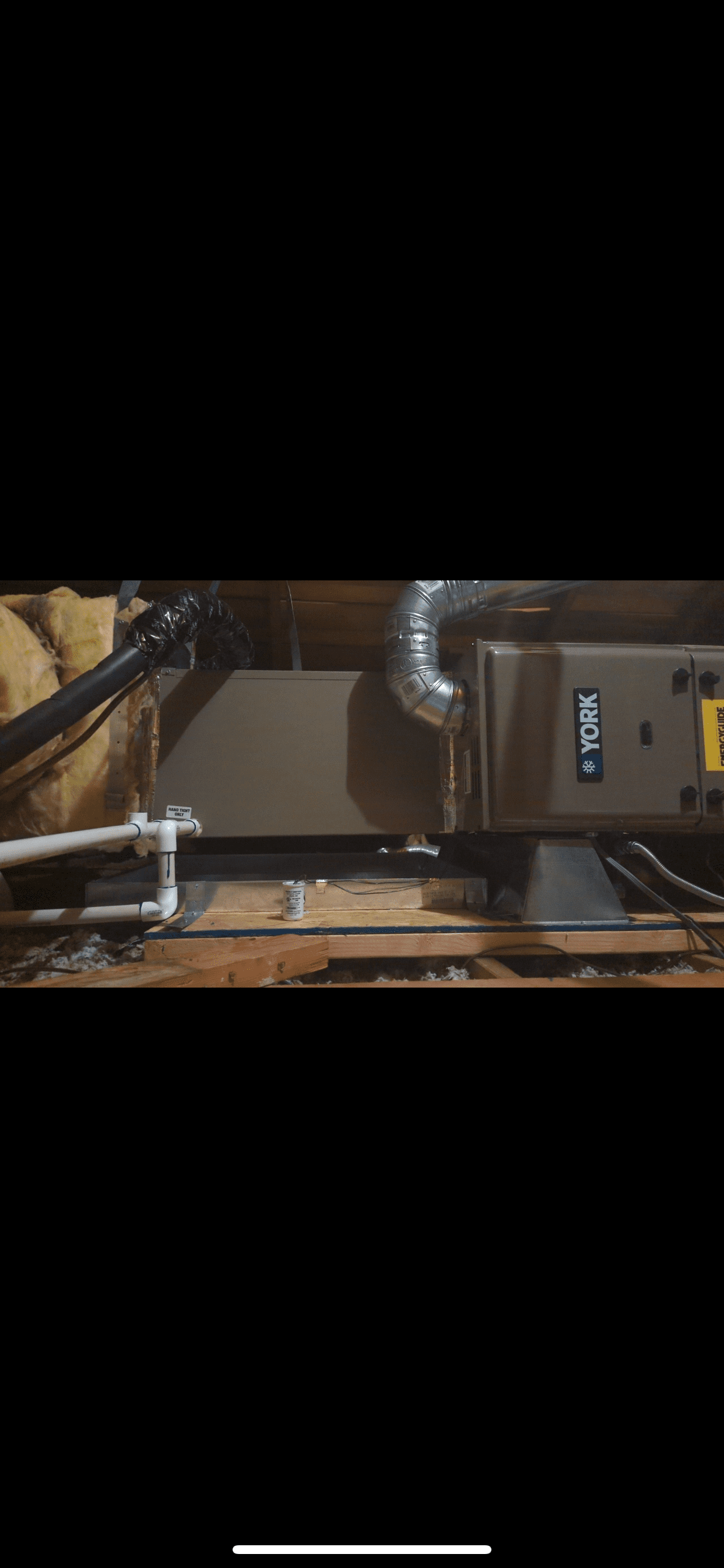 A picture of a ventilation system in an attic.