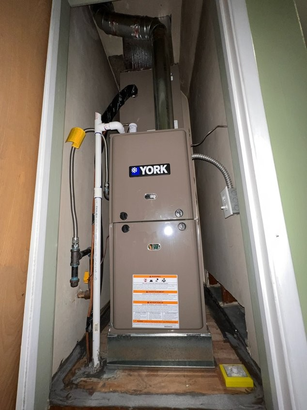 A york air conditioner is sitting in a narrow room.