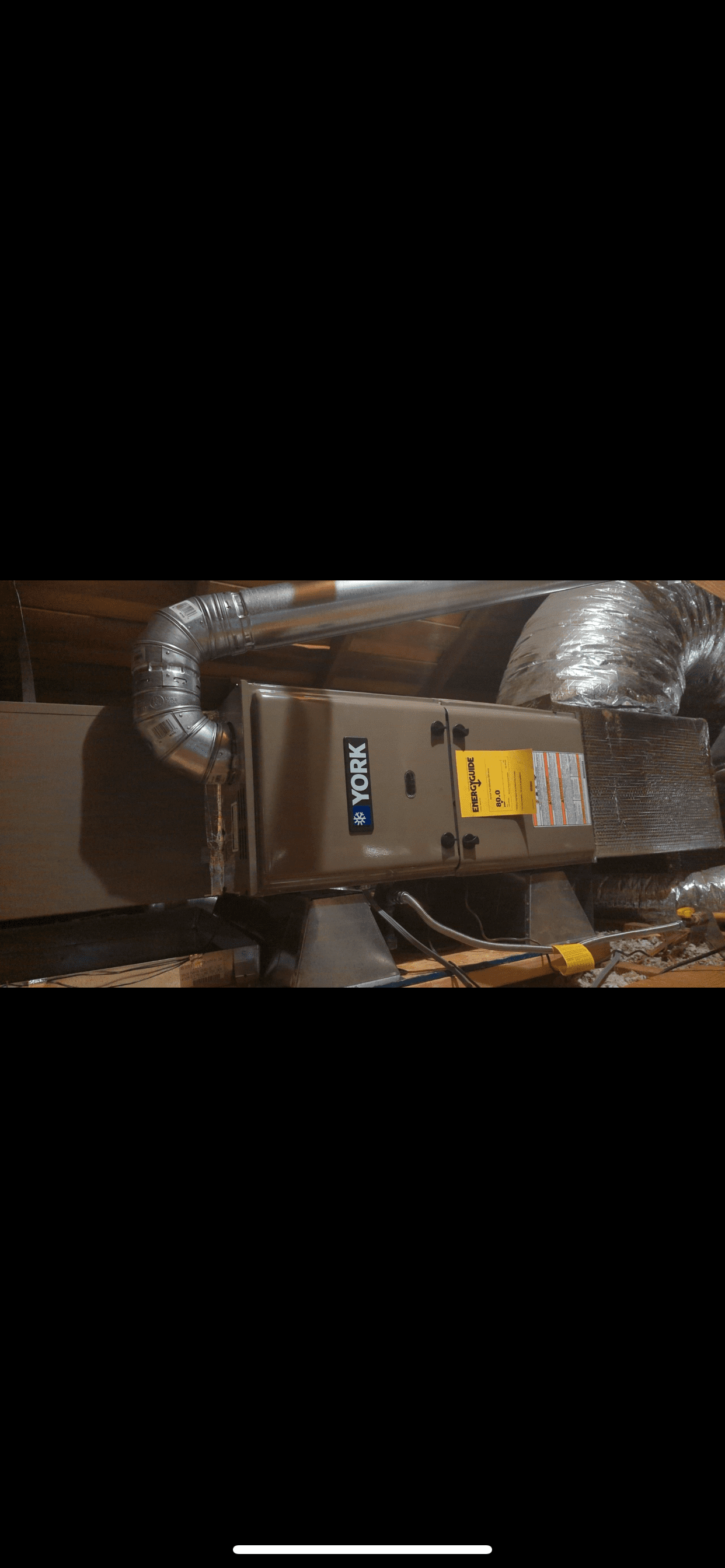 A picture of an air conditioner in a basement.