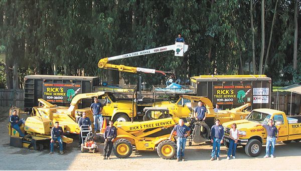 A group of men are posing for a picture in front of a truck. A group of men are posing for a picture in front of a truck.