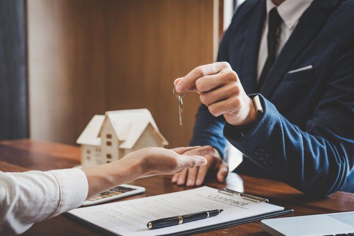 Real estate agent Sales manager holding filing keys