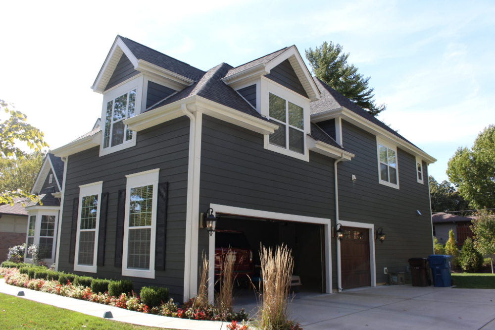 A large house with a garage and a lot of windows