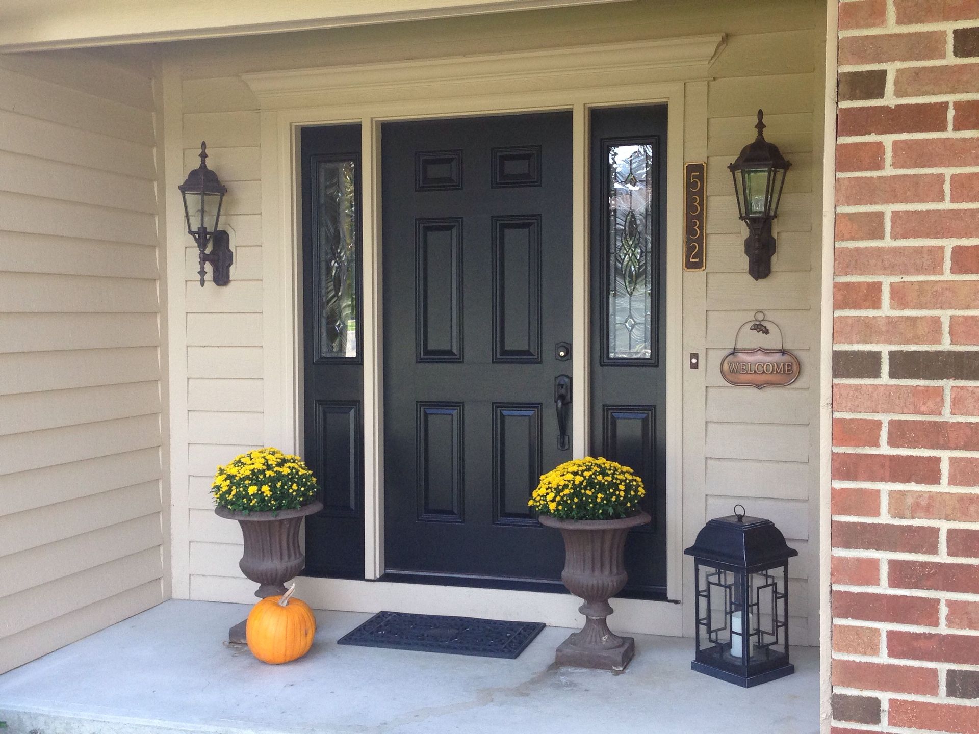 The front door of a house with a black door
