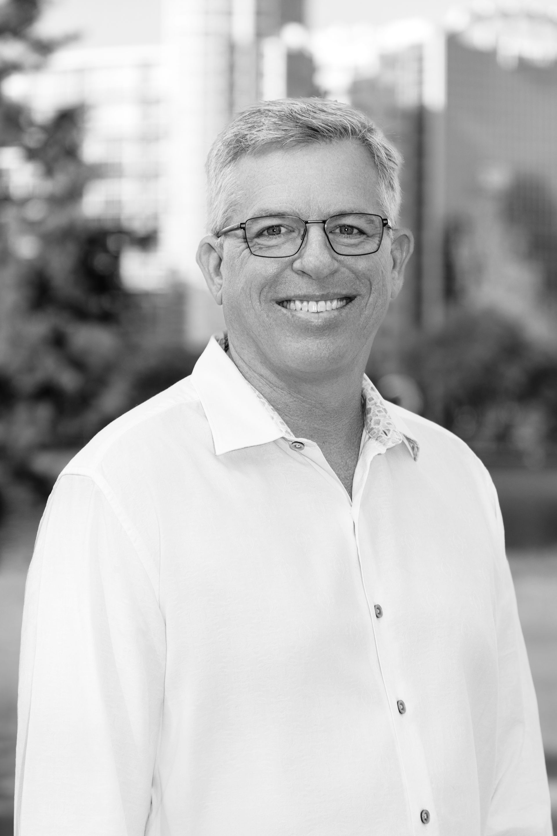 A black and white photo of a Bob Ziegenfuss smiling for the camera.