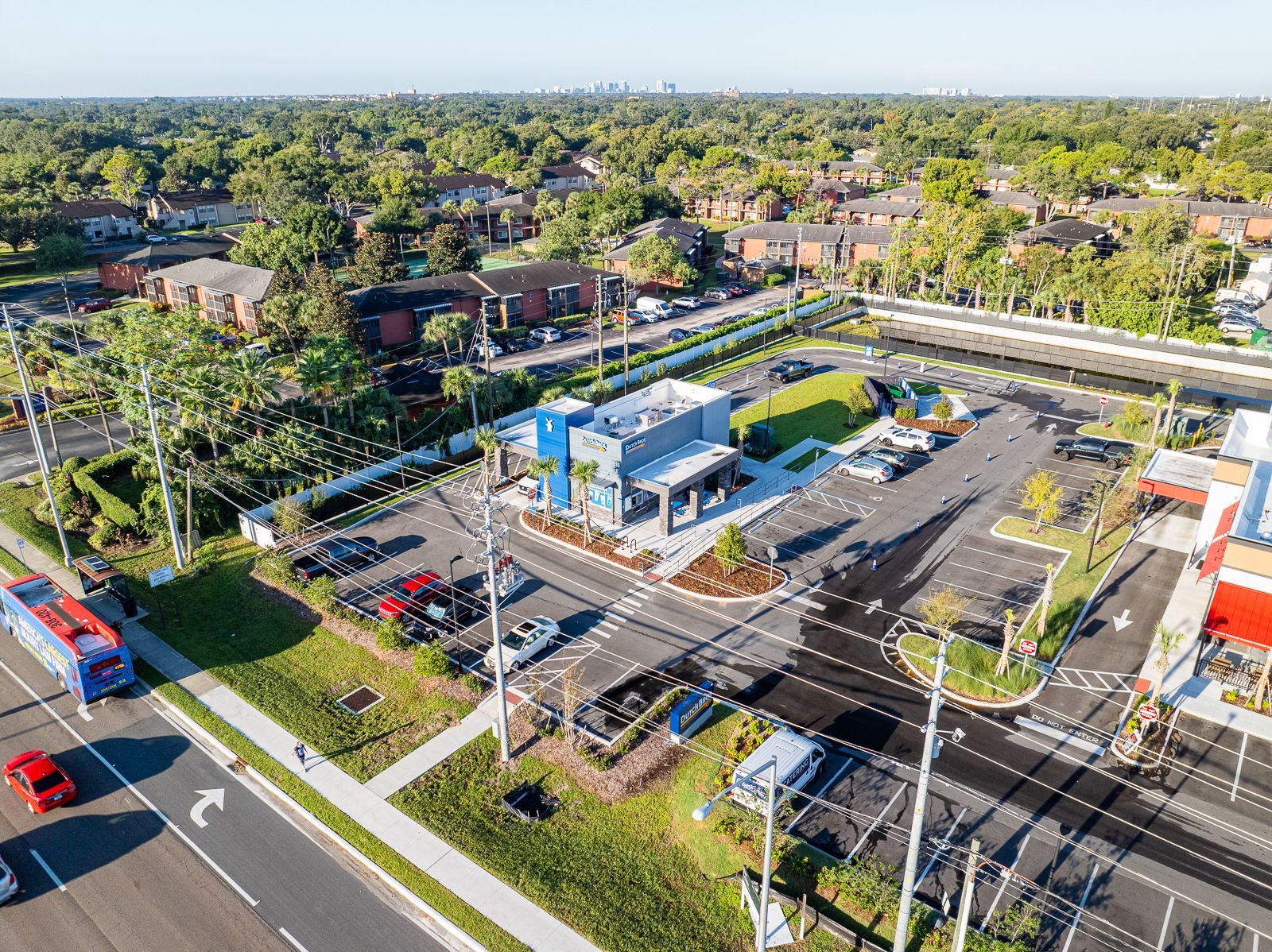 An aerial view of a parking lot next to a road.