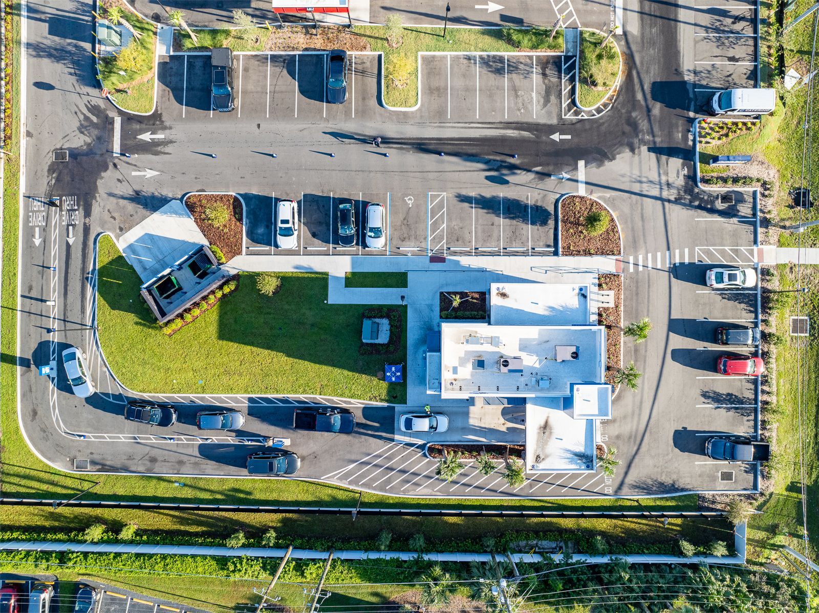 An aerial view of a parking lot with cars parked in it