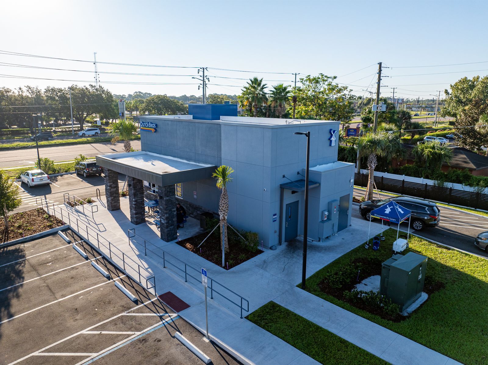 An aerial view of a building with a parking lot in front of it.