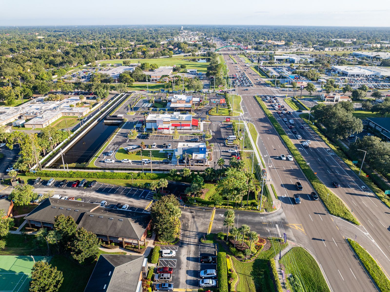 An aerial view of a city with a lot of cars on the roads.