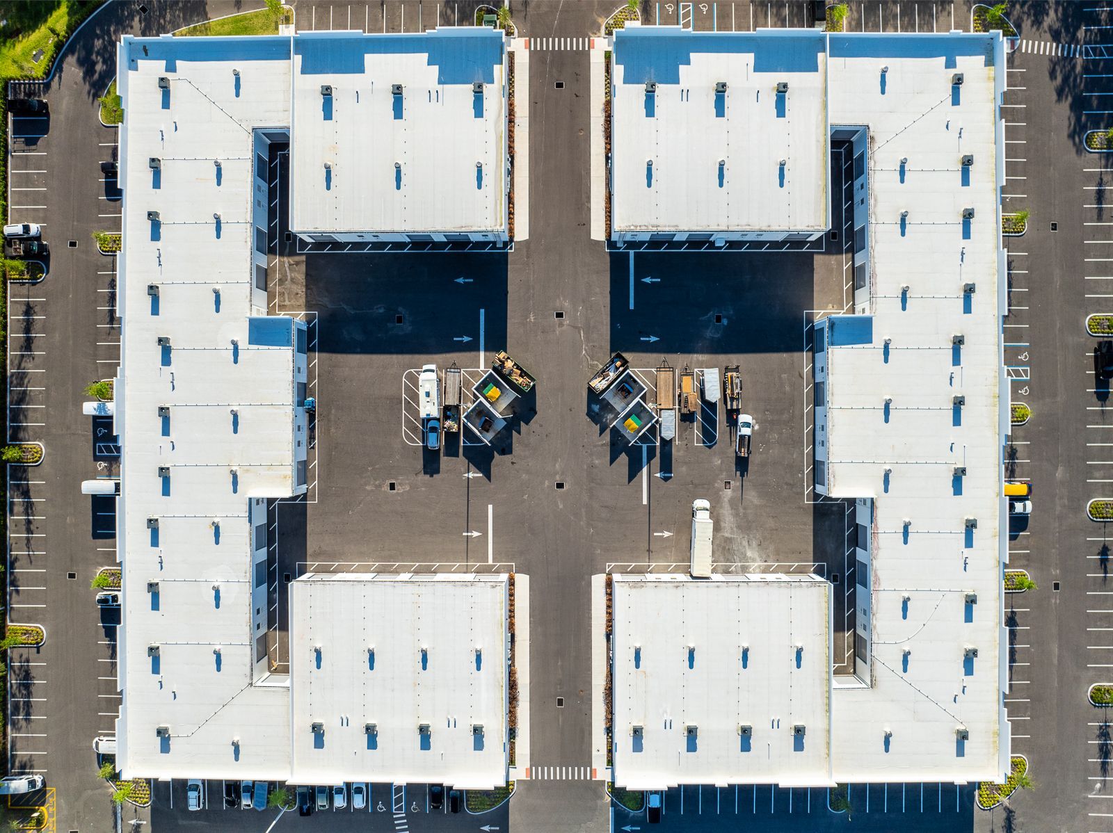 An aerial view of a large building with white roofs