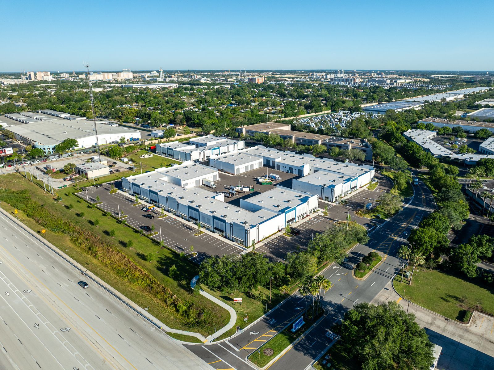 An aerial view of a large industrial area with lots of buildings and trees.