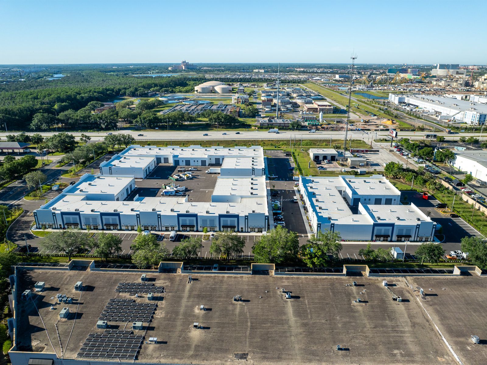 An aerial view of a large building with a lot of cars parked in front of it