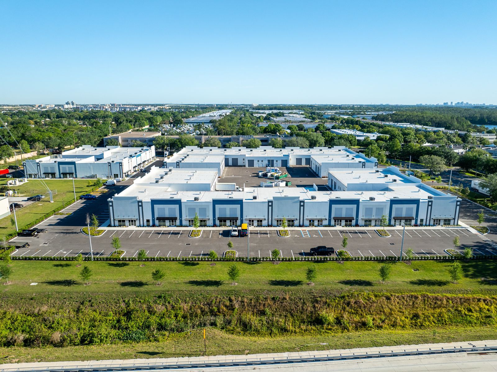 An aerial view of a large building with lots of cars parked in front of it