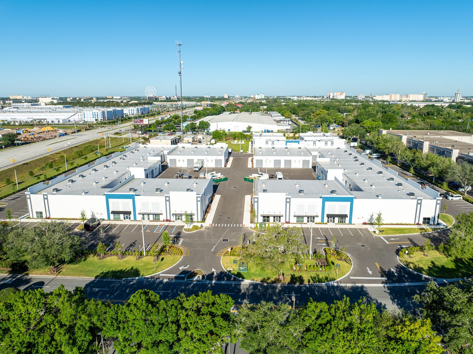 An aerial view of a large industrial area with lots of buildings and trees.