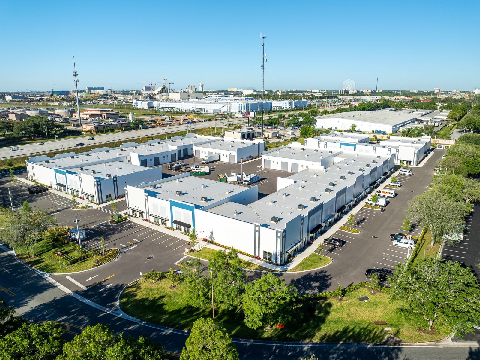 An aerial view of a large industrial area with lots of buildings and trees.