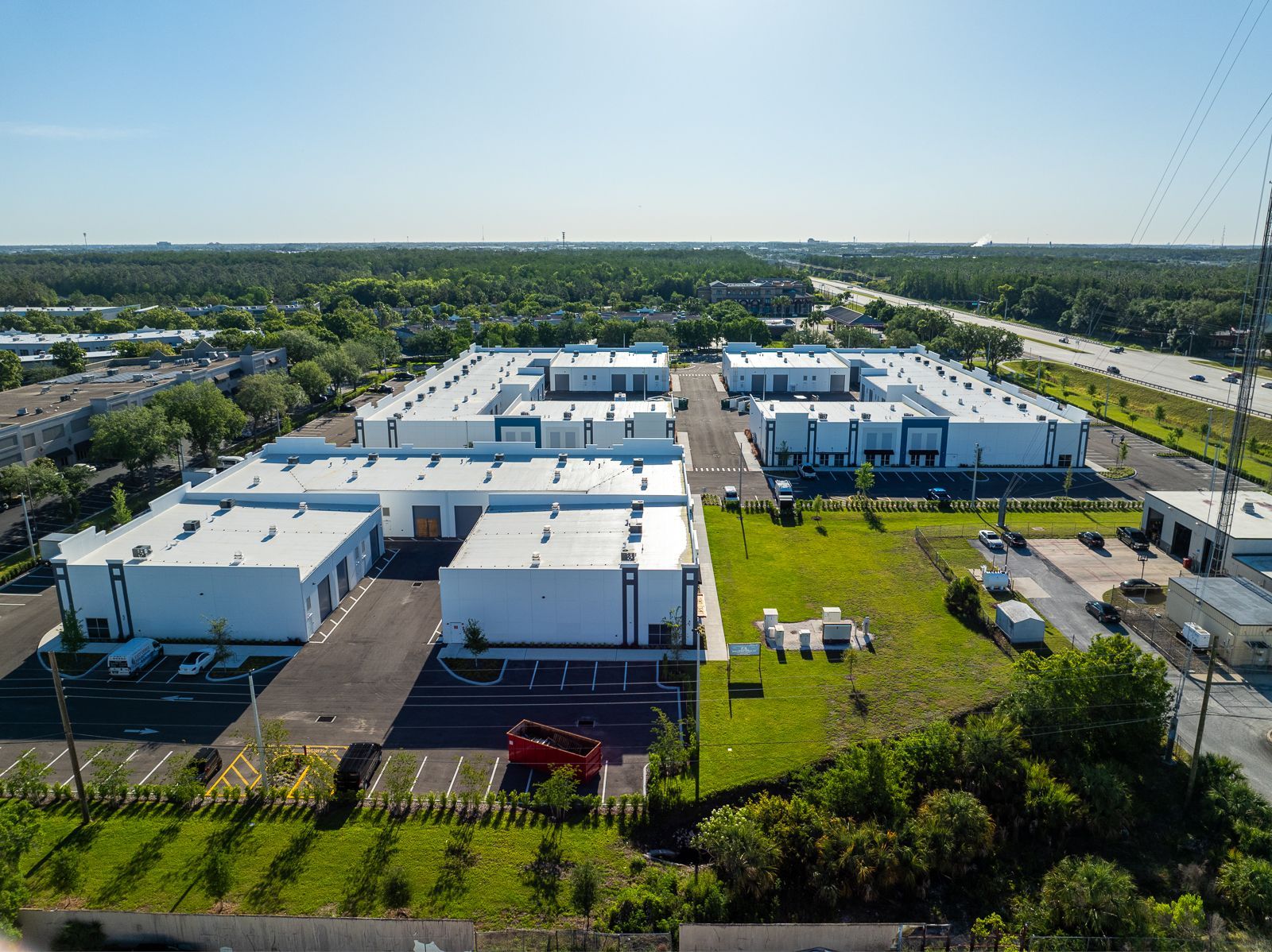 An aerial view of a large industrial area with lots of buildings and trees.