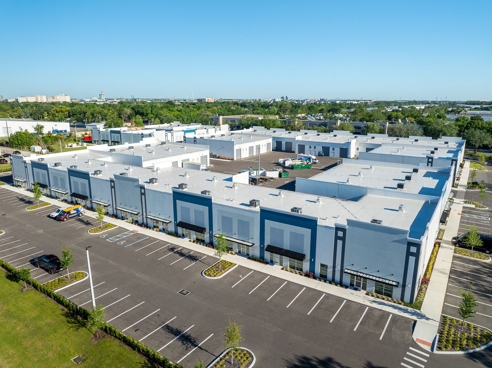 An aerial view of a large building with a parking lot in front of it.