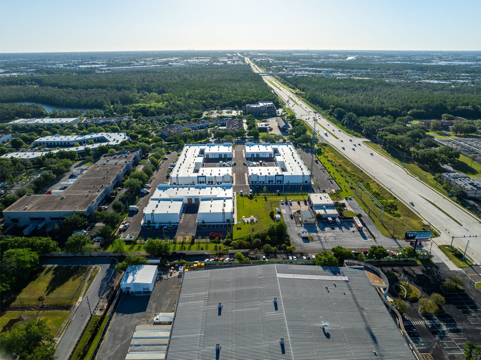 An aerial view of a city with a lot of buildings and a highway.