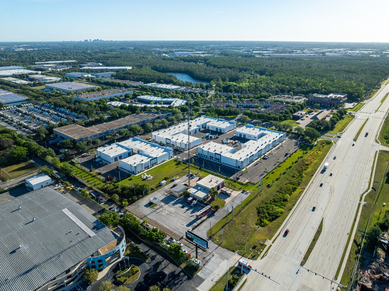 An aerial view of a city with a lot of buildings and a highway.