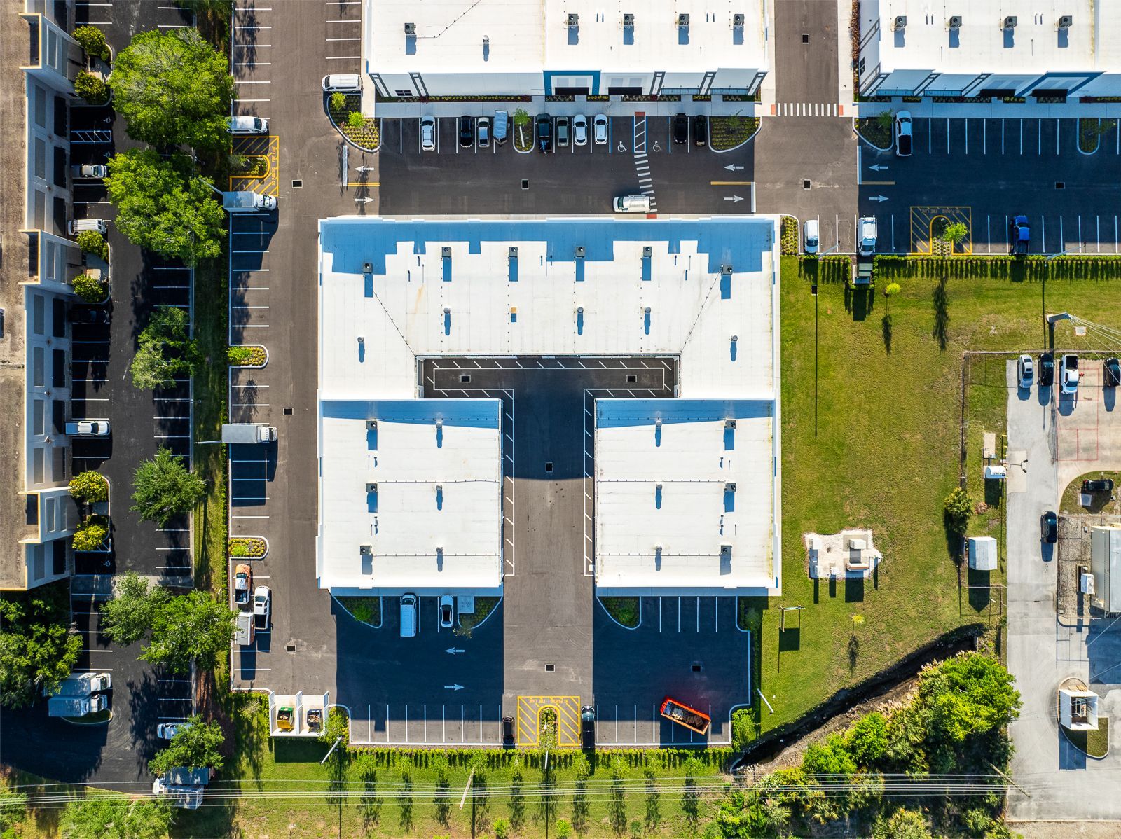 An aerial view of a building with white roofs