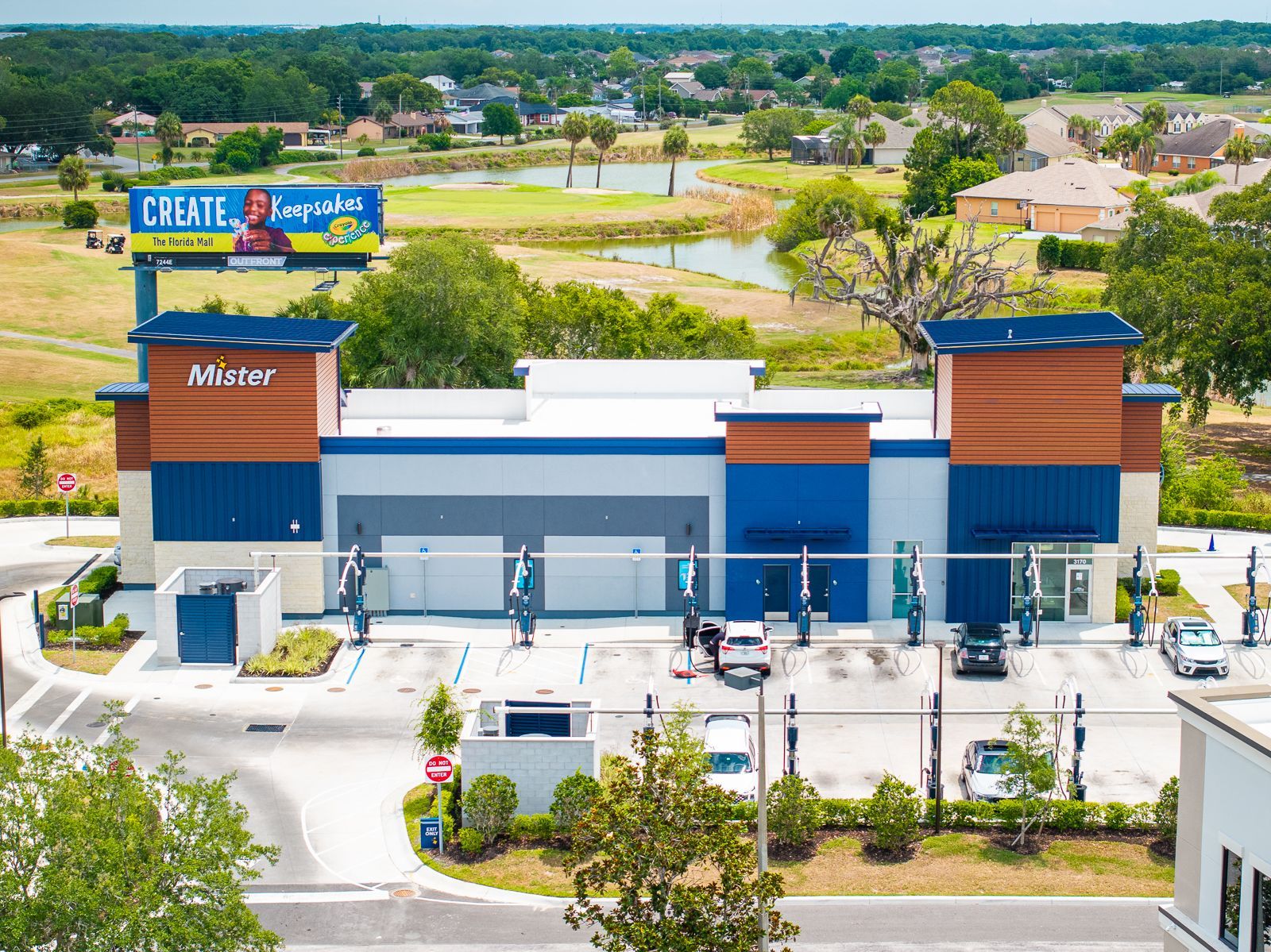 An aerial view of a dental office with a billboard above it