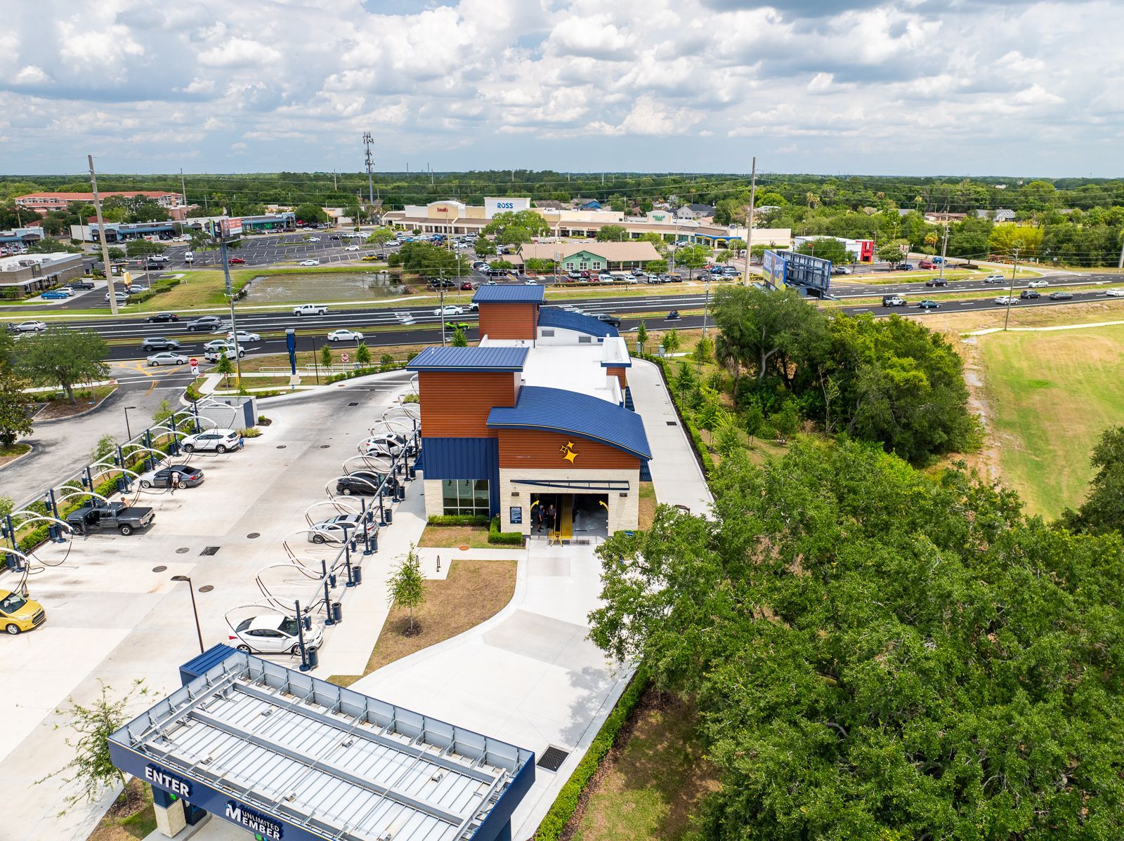 An aerial view of a large building with a lot of cars parked in front of it.