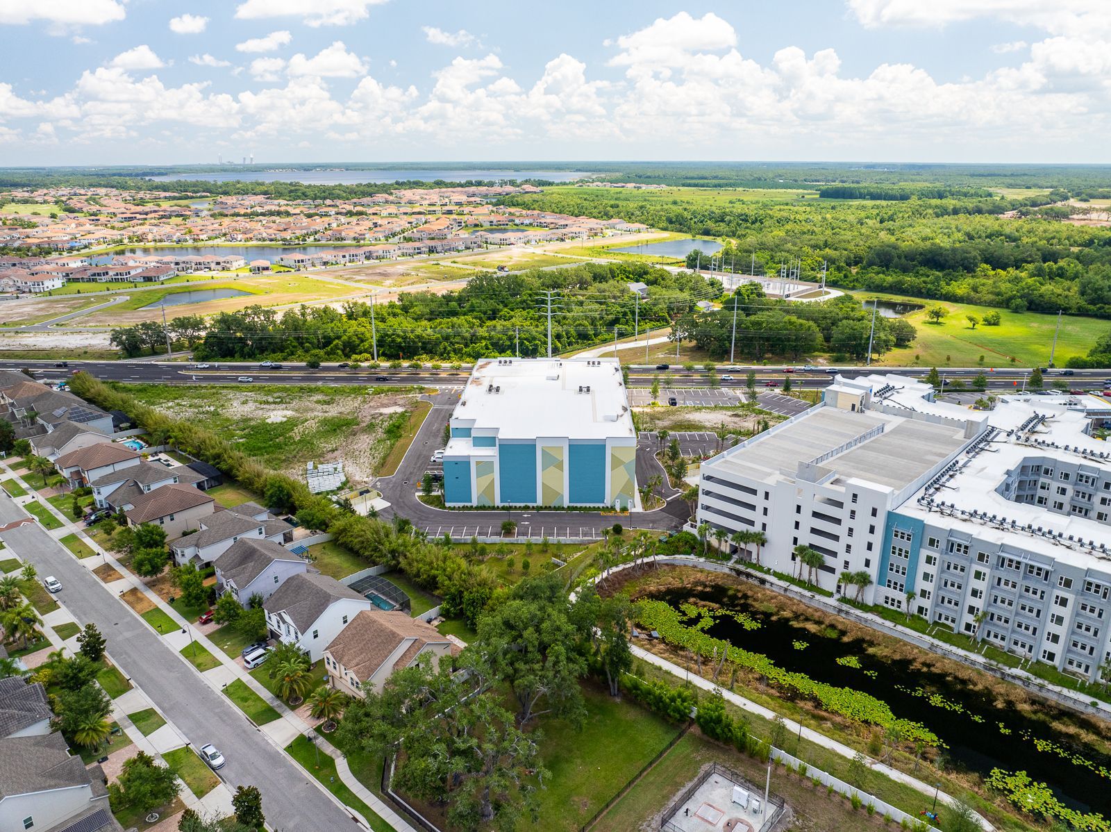An aerial view of a large building in the middle of a residential area.