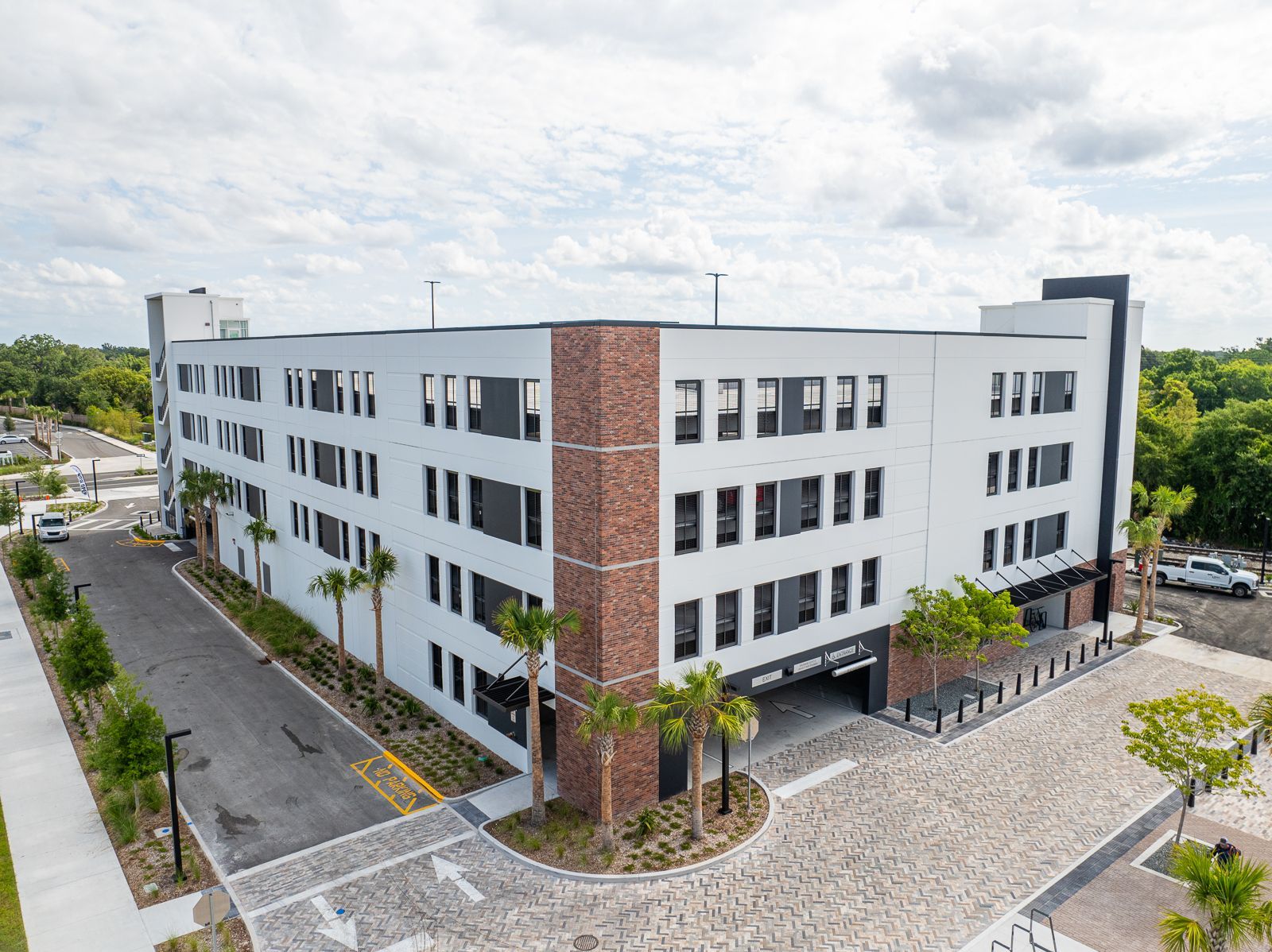 An aerial view of a large building with cars parked in front of it.