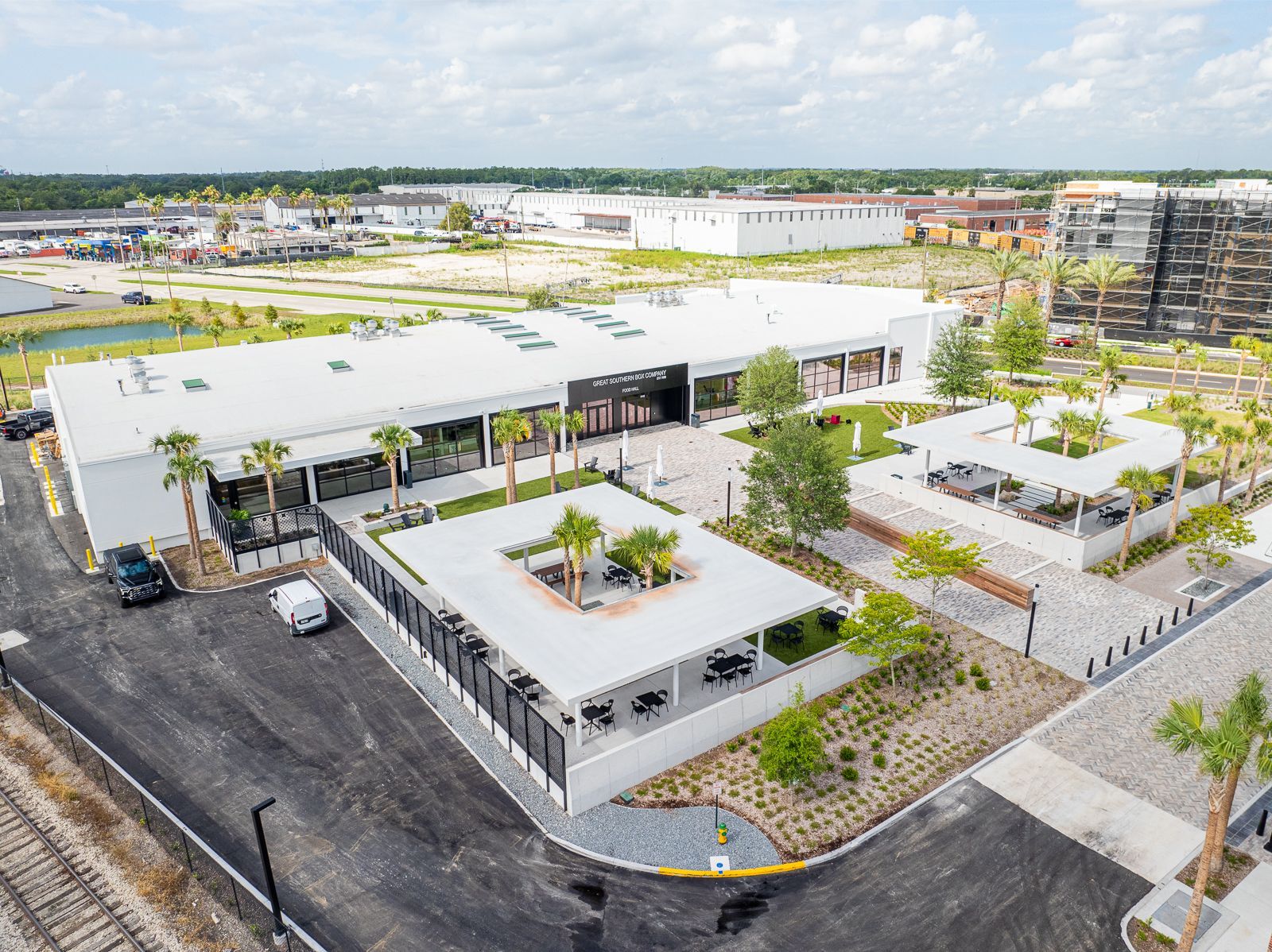 An aerial view of a large building with a lot of cars parked in front of it.