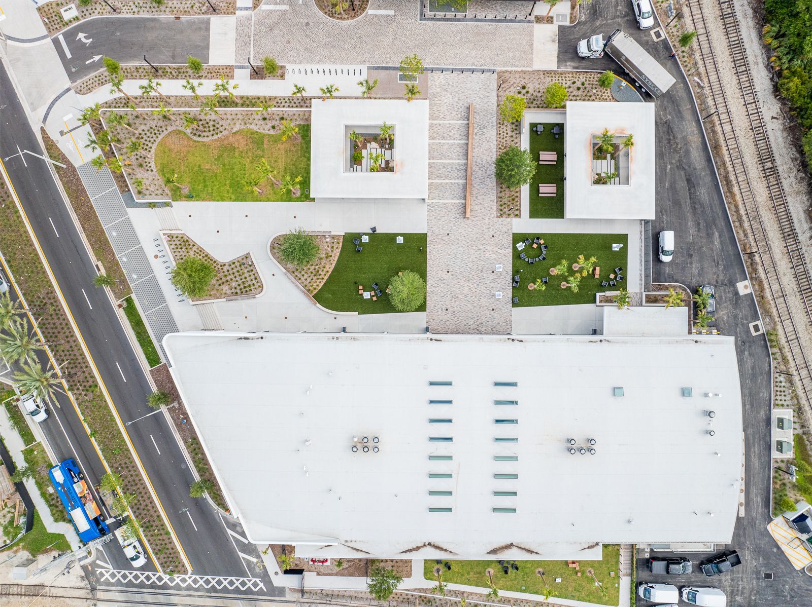 An aerial view of a large building with a white roof