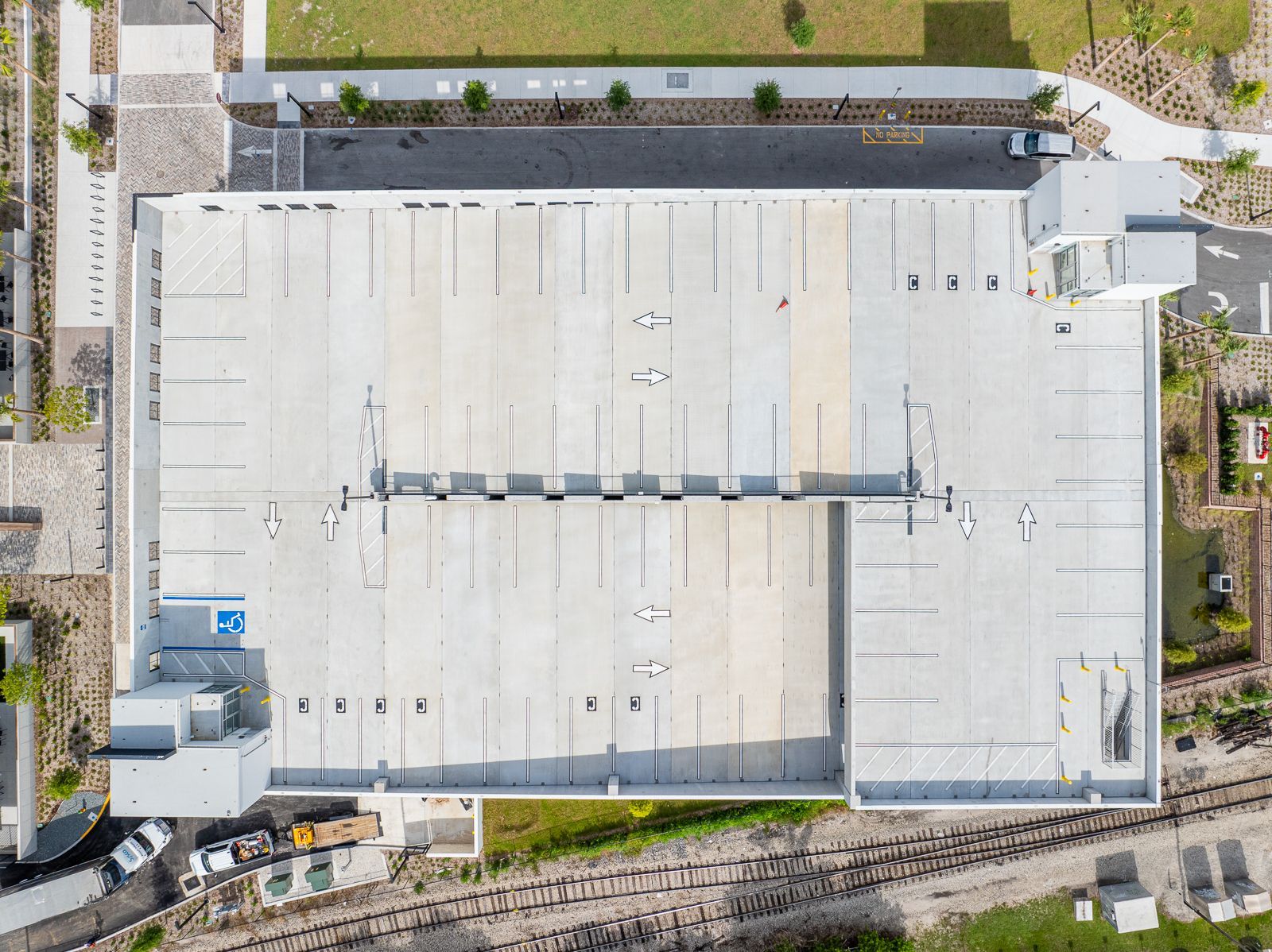 An aerial view of a large building with a lot of parking spaces.