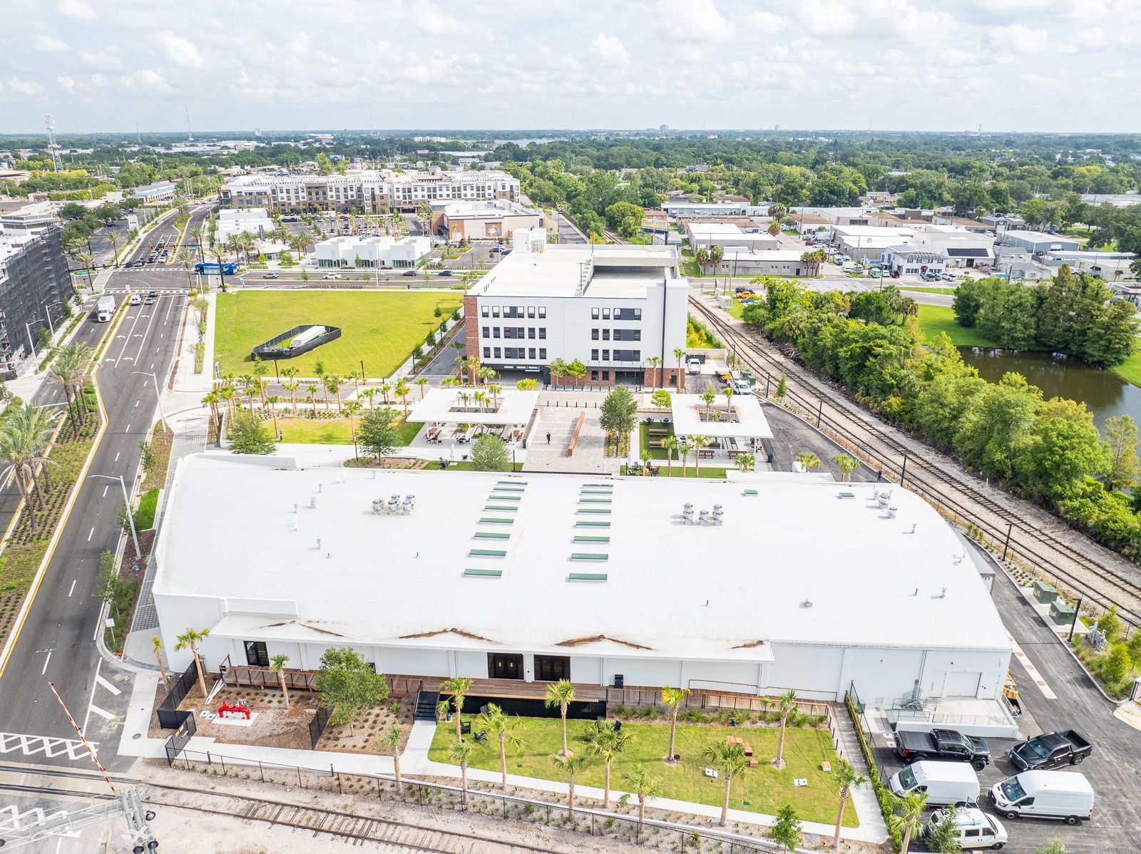 An aerial view of a large white building in the middle of a city.