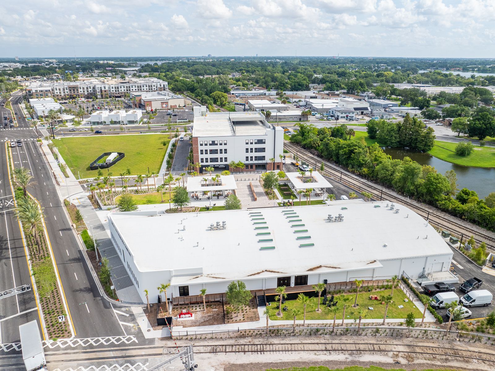 An aerial view of a large white building in the middle of a city.