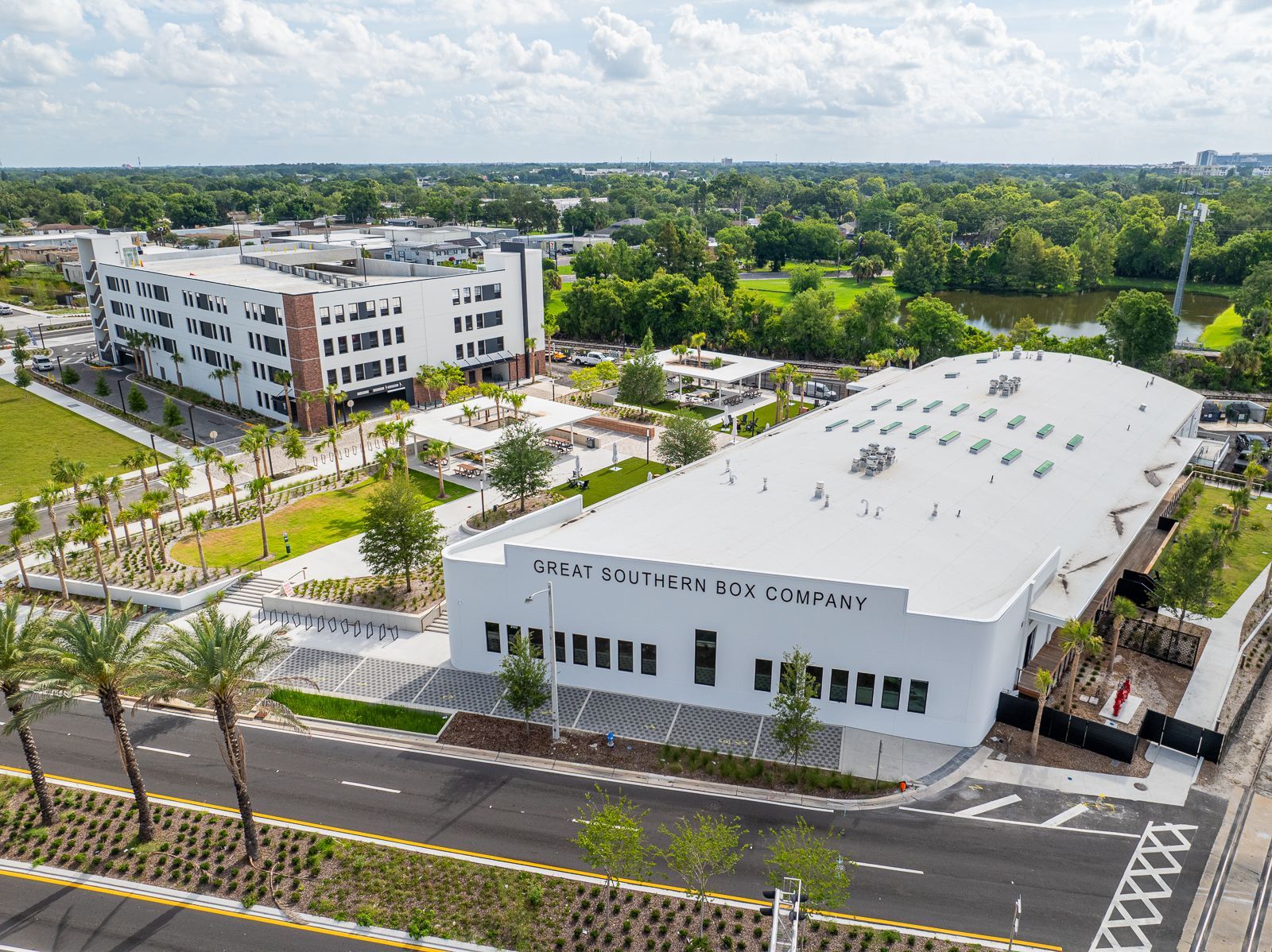 An aerial view of a large white building with a white roof