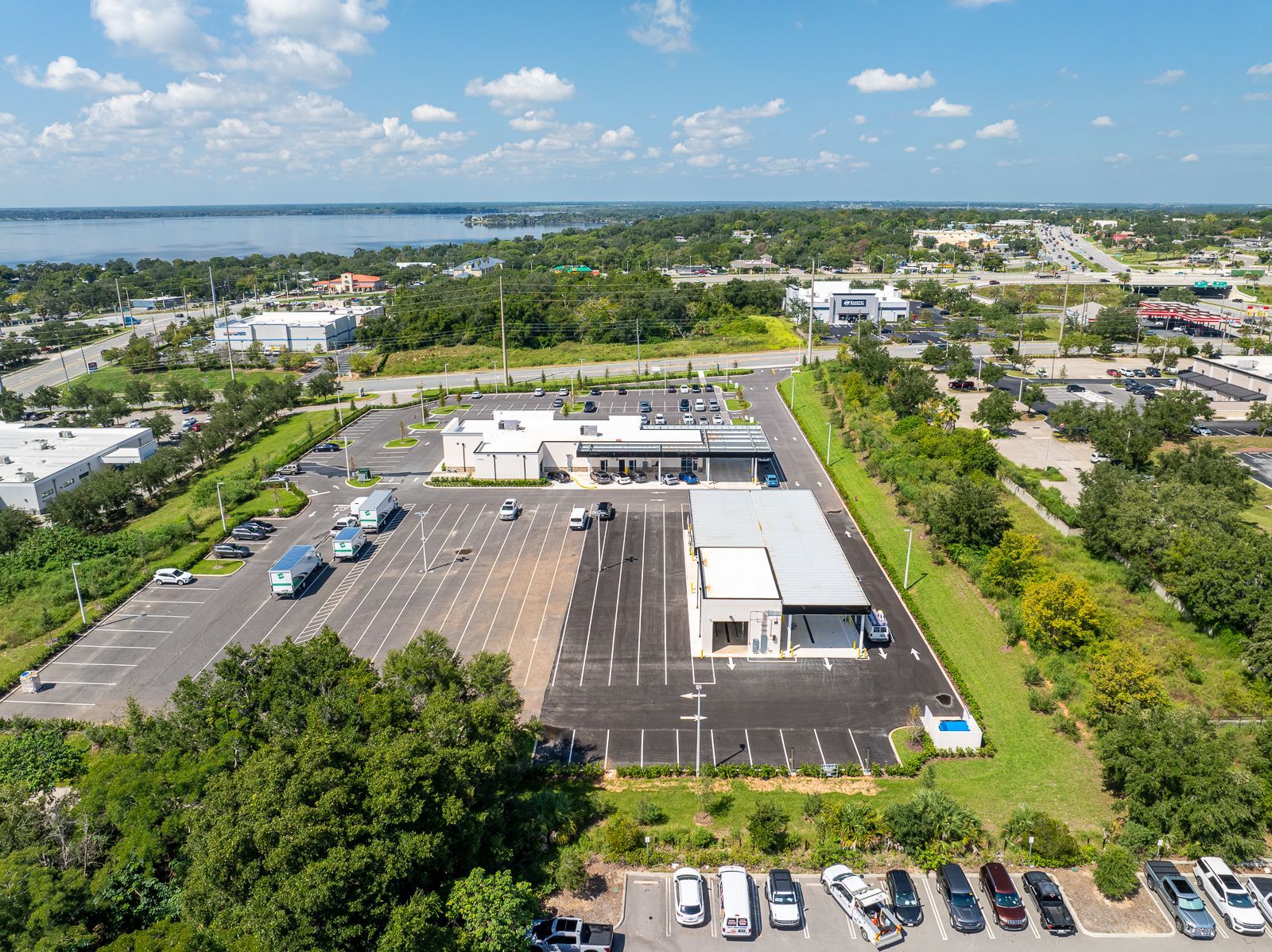 An aerial view of a parking lot with a lot of cars parked in it.