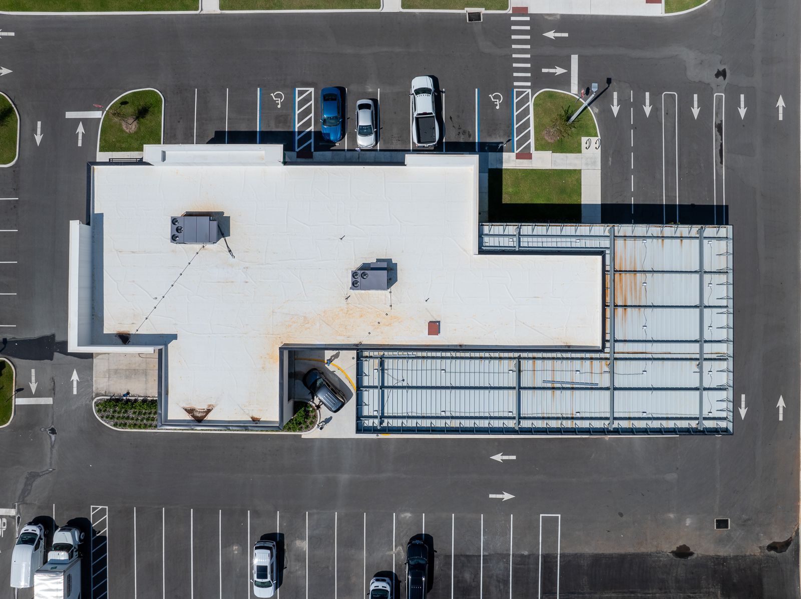 An aerial view of a building in a parking lot