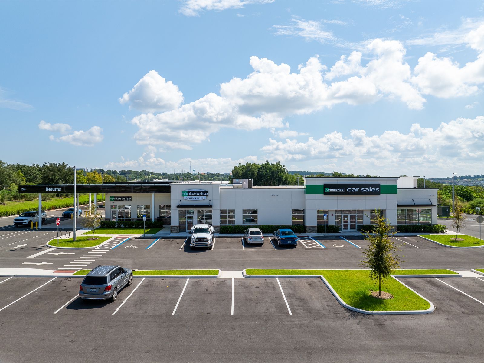 A parking lot with cars parked in front of a building