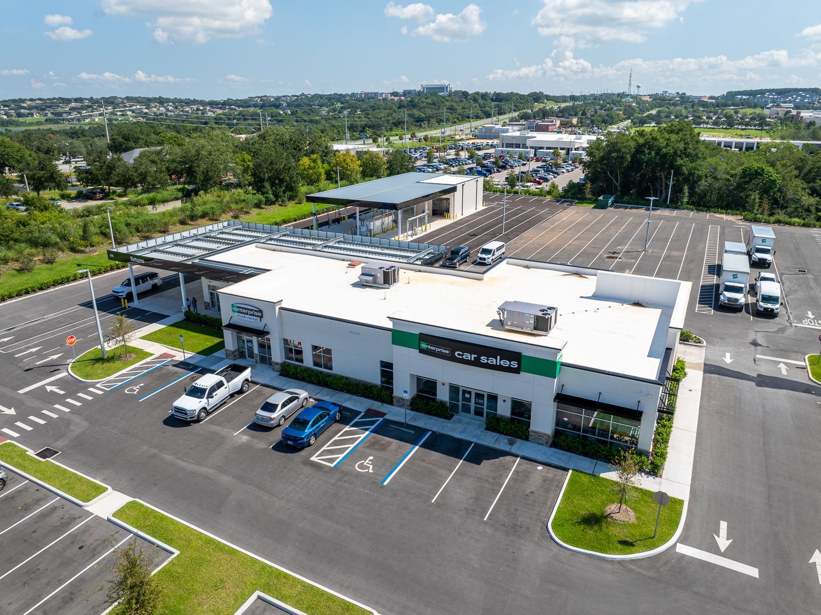 An aerial view of a large building with a parking lot in front of it