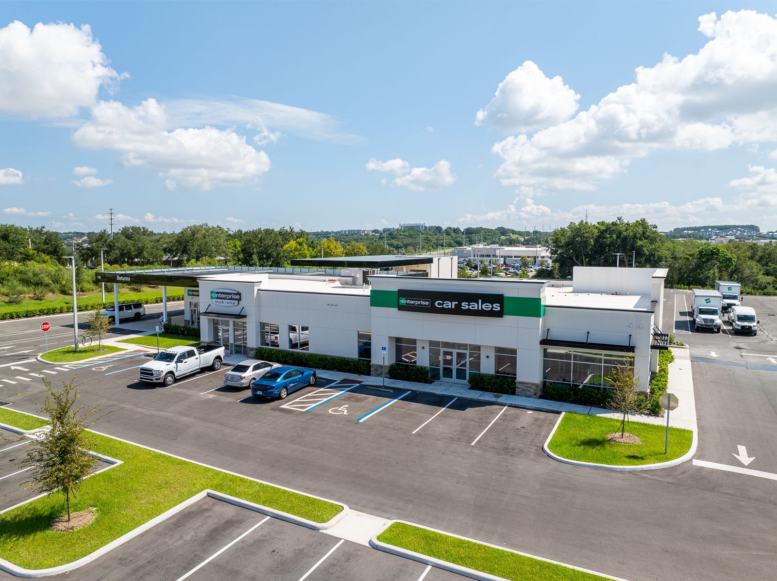 An aerial view of a starbucks coffee shop with cars parked in front of it.