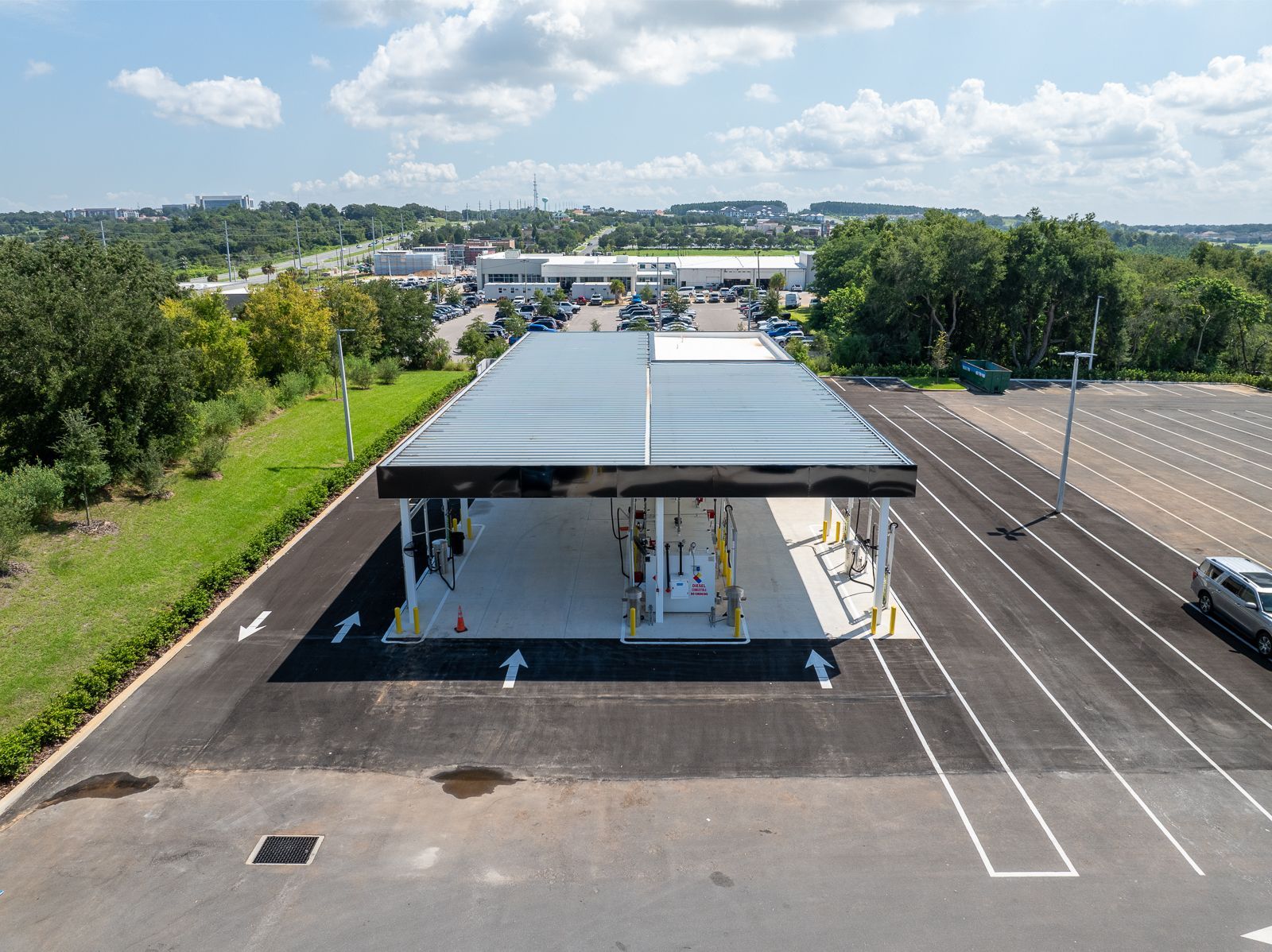 An aerial view of a parking lot with a building in the middle