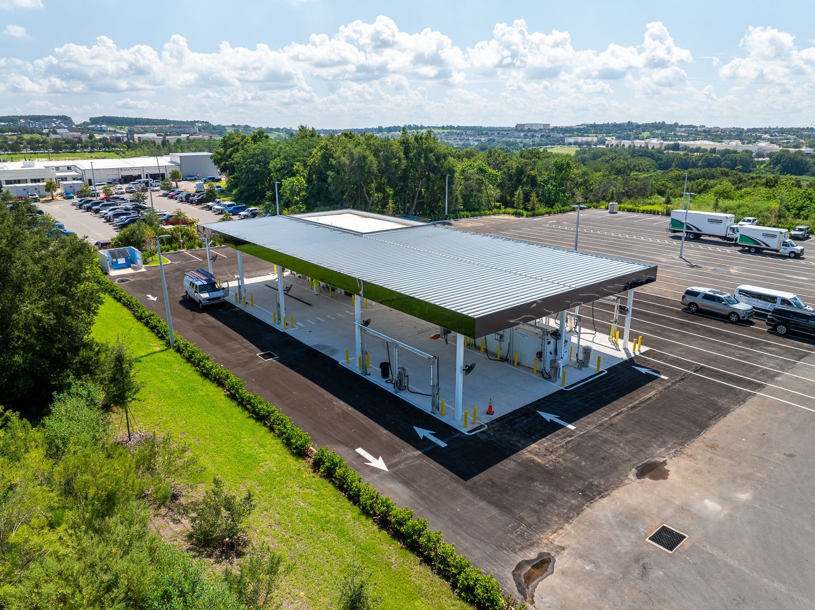 An aerial view of a gas station with cars parked in front of it.