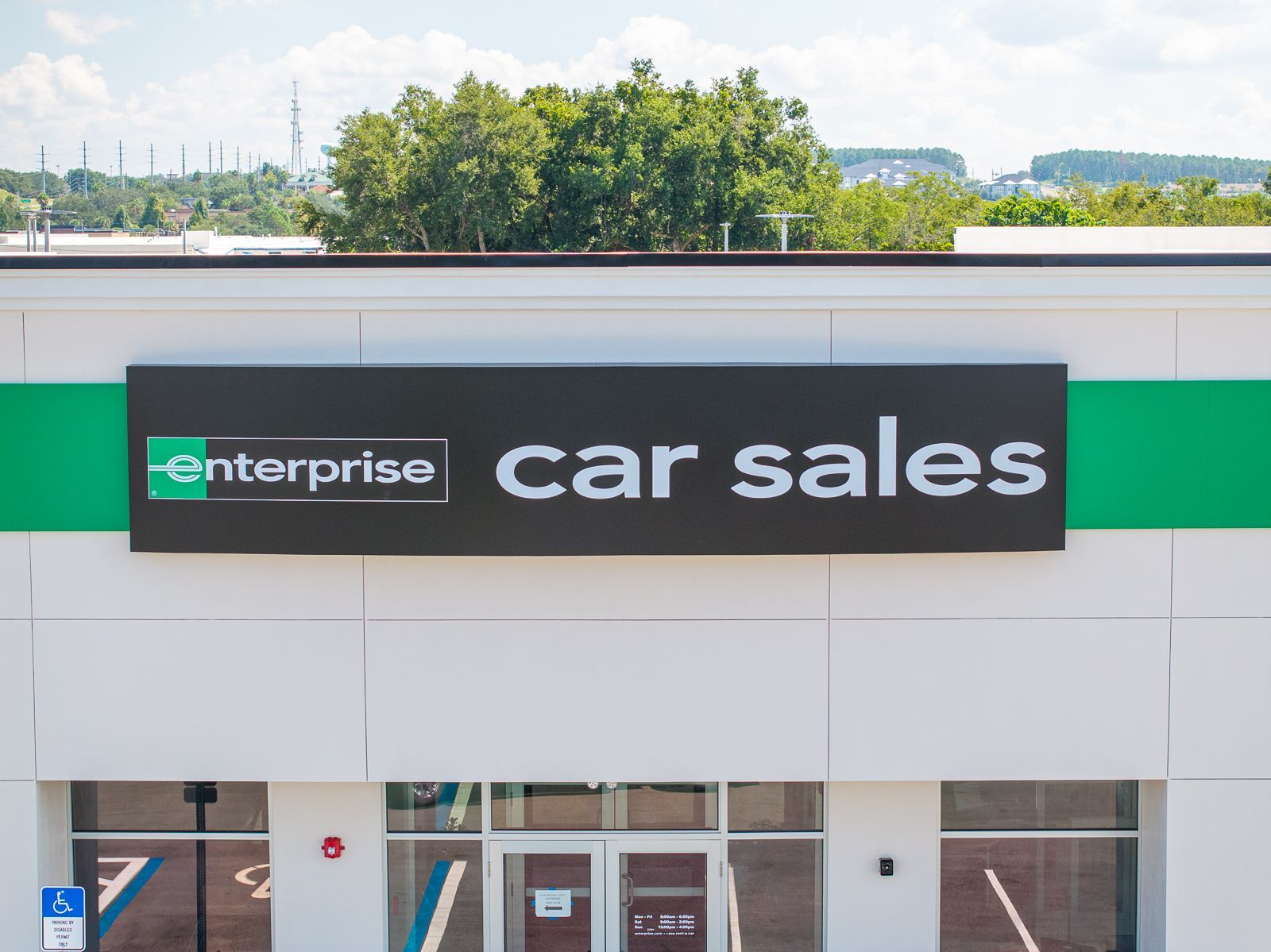 Enterprise car sales has a large sign above the door