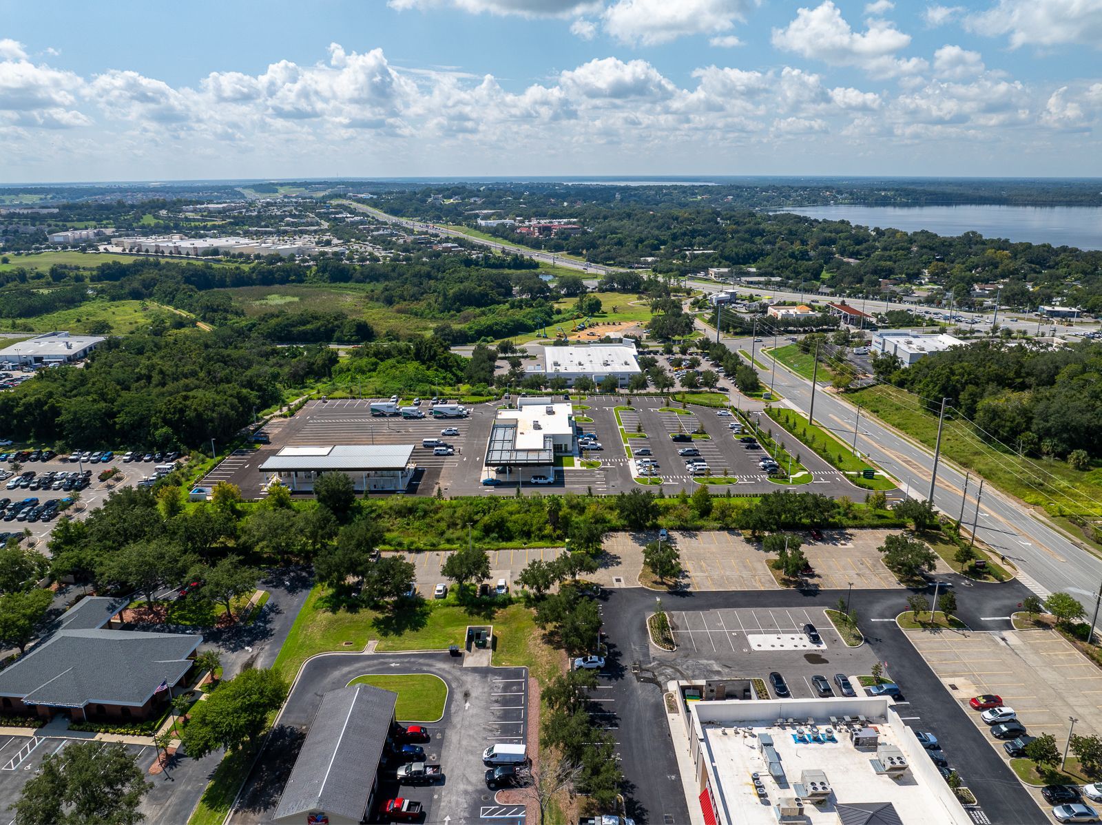 An aerial view of a city with a lot of buildings and parking lots.