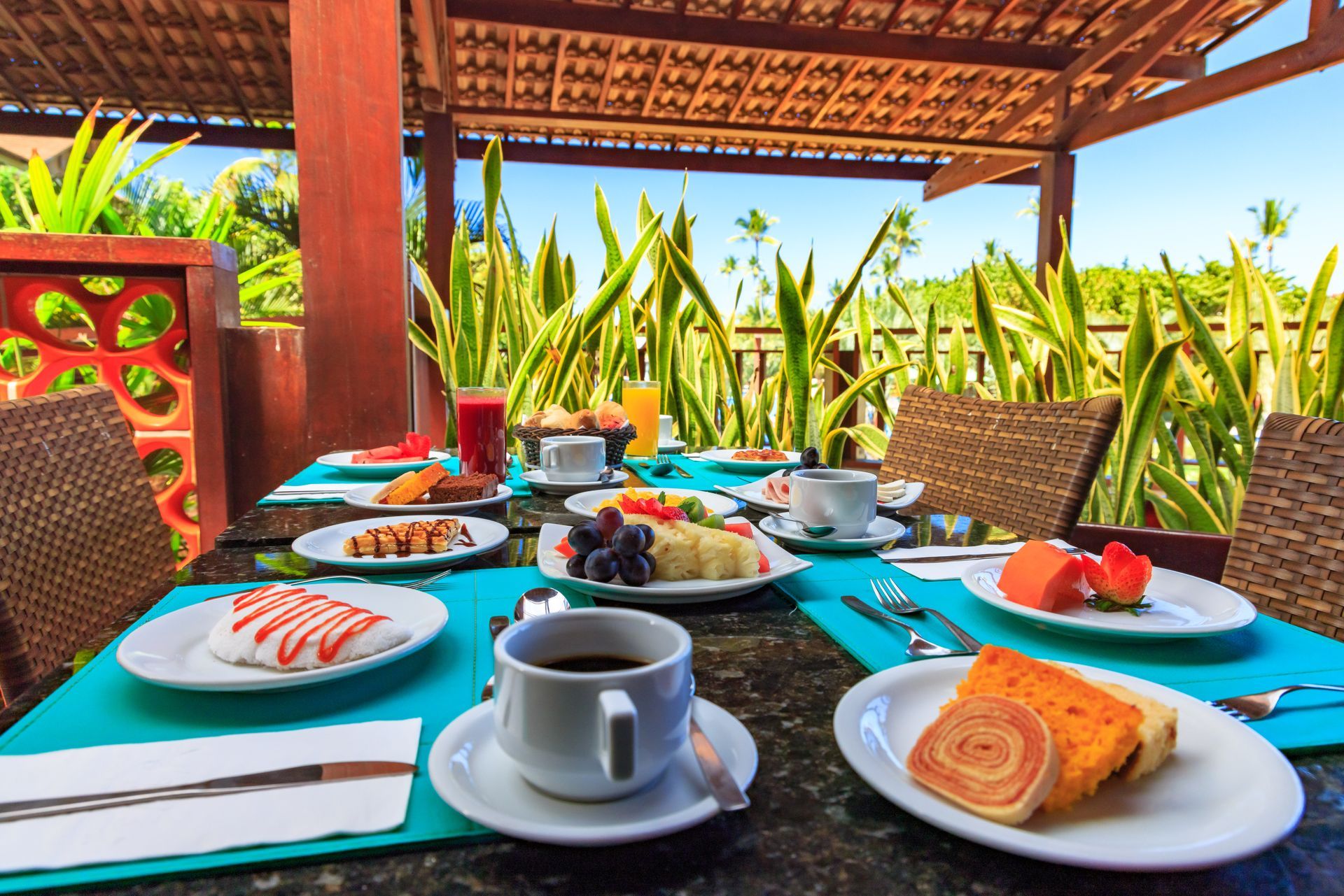 Uma mesa coberta com pratos de comida e uma xícara de café.