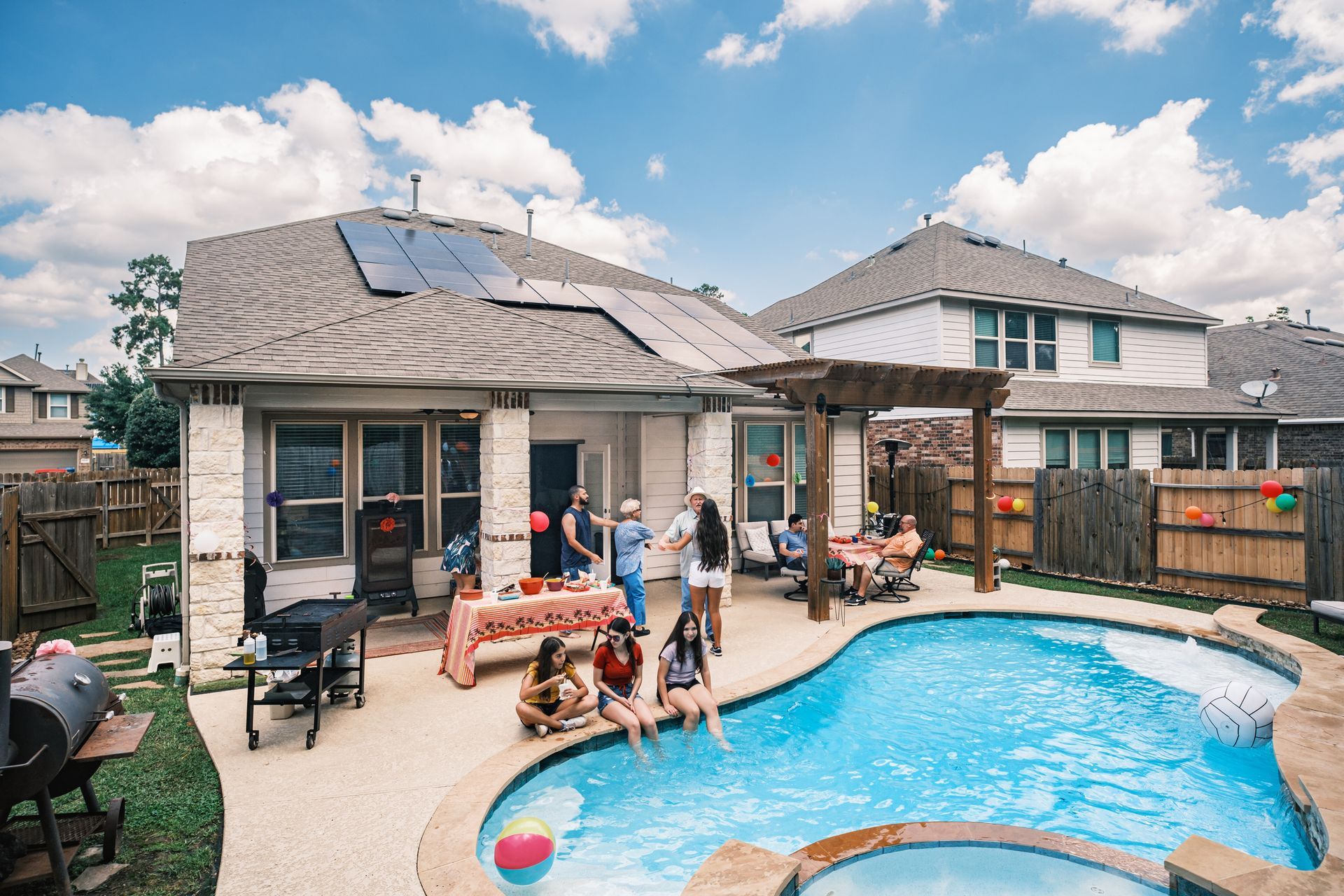 Picture of a family having a party in their pool area
